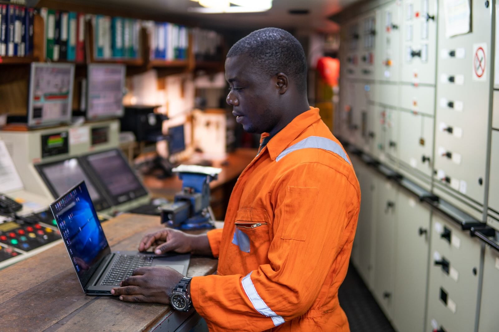 Engineer working at a control panel in a plant control room