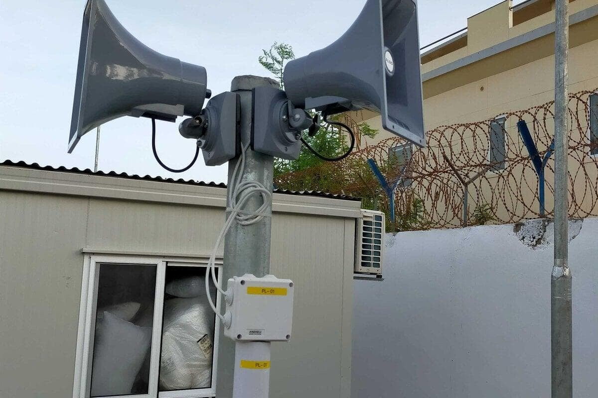 Secured compound with mast, containers and protective perimeter